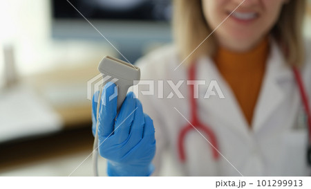 Ultrasonic machine sensor in hands of doctor therapist in clinic closeup Ultrasonic machine sensor in hands of doctor therapist in clinic closeup 101299913