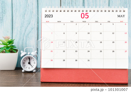 The May 2023 Monthly desk calendar for the organizer to plan 2023 year with alarm clock on wooden table. The May 2023 Monthly desk calendar for the organizer to plan 2023 year with alarm clock on wooden table. 101301007