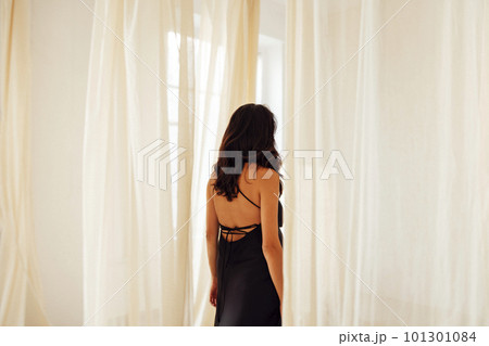 Attractive young woman in classic evening black dress. Attractive young woman in classic evening black dress. 101301084