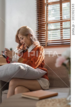 Portrait of pretty young woman looking at pictures from the camera Portrait of pretty young woman looking at pictures from the camera 101302143