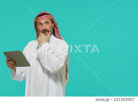 Online shopping in Middle East. Arab man holds tablet and selects goods and services. High quality photo Online shopping in Middle East. Arab man holds tablet and selects goods and services. High quality photo 101303007