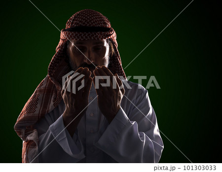 Arab man in prayer with his palms in front of his face. It conveys the devotion and spirituality inherent in Islamic culture. High quality photo Arab man in prayer with his palms in front of his face. It conveys the devotion and spirituality inherent in Islamic culture. High quality photo 101303033