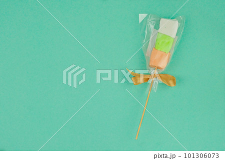Traditional colored marshmallows for the holiday on green background. Top view. Traditional colored marshmallows for the holiday on green background. Top view. 101306073