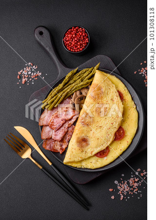 Delicious fresh omelet with cherry tomatoes, bacon, asparagus and spices Delicious fresh omelet with cherry tomatoes, bacon, asparagus and spices 101308118