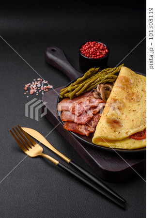 Delicious fresh omelet with cherry tomatoes, bacon, asparagus and spices Delicious fresh omelet with cherry tomatoes, bacon, asparagus and spices 101308119