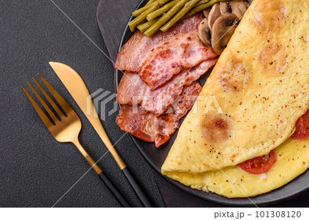 Delicious fresh omelet with cherry tomatoes, bacon, asparagus and spices 101308120