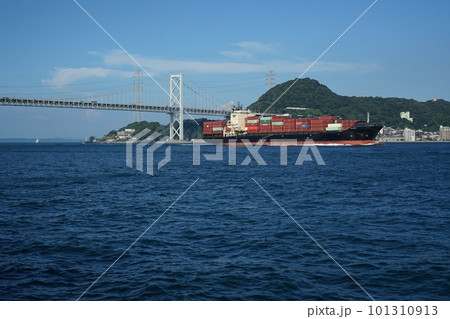 橋を通過し関門海峡を西進するコンテナ船 101310913