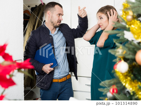 Unhappy woman talking with collector 101314890