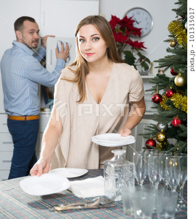 Girl with husband serving table Girl with husband serving table 101315017