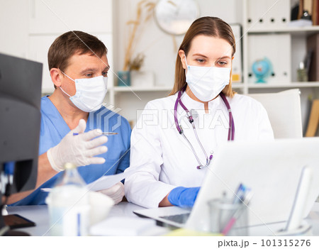 Two physicians working with laptop 101315276