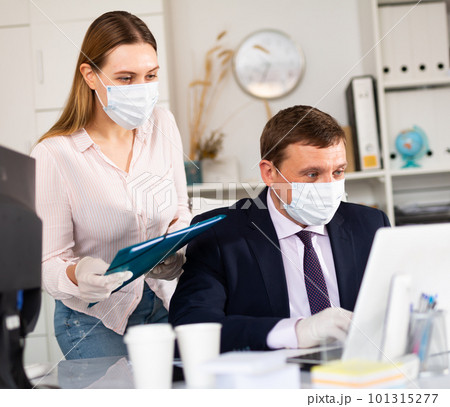Director gives instructions to assistant in office 101315277