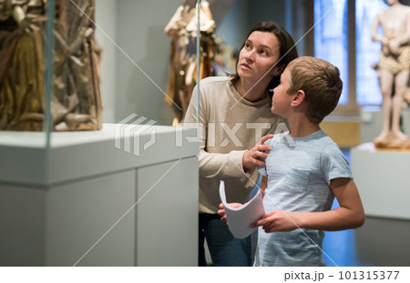 Woman and boy visiting sculptures exhibition Woman and boy visiting sculptures exhibition 101315377