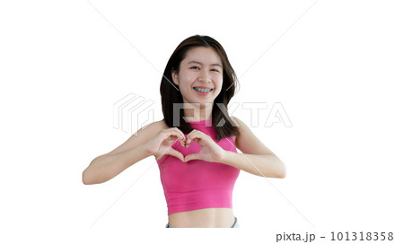 Asian young woman with bright smile making heart symbol shape with hands, Symbol of love and romance, Give each other cuteness and create smiles for each other, Positive thinking concept. 101318358