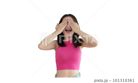 Young woman covering her face and eyes with her hands isolated, Cover your eyes with your hands for fear or prying eyes, Sneak peek, Yellow background. 101318361