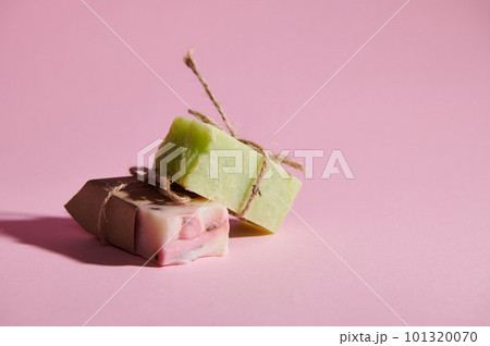 A stack of cold-pressed organic soap bars with natural ingredients on isolated pink background with copy advertising space. Healthy lifestyle and body care concept. Home spa. Hygiene. Beauty treatment A stack of cold-pressed organic soap bars with natural ingredients on isolated pink background with copy advertising space. Healthy lifestyle and body care concept. Home spa. Hygiene. Beauty treatment 101320070