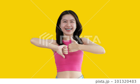 Thumbs up and thumbs down, Young woman doing hand sign thumbs up and thumbs down, Pros and cons, Success and failure, Right and wrong. Thumbs up and thumbs down, Young woman doing hand sign thumbs up and thumbs down, Pros and cons, Success and failure, Right and wrong. 101320483