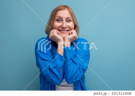 coquette middle-aged woman in an attractive image on a blue background with copy space 101322806