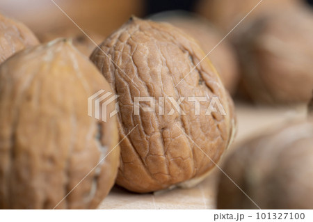 Unpeeled walnut harvest on the table 101327100