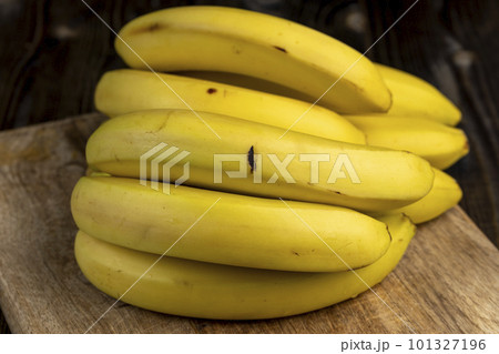 a bunch of bananas lies on the table a bunch of bananas lies on the table 101327196