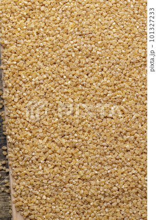 Fresh wheat porridge but cooked scattered on the table 101327233
