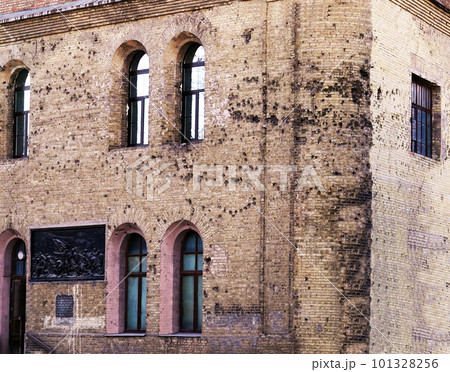 Kiev, Ukraine November 22, 2019: Ancient city building of the times of the 1917 revolution with traces of bullets on the facade of the building in Kiev near Arsenalnaya metro station Kiev, Ukraine November 22, 2019: Ancient city building of the times of the 1917 revolution with traces of bullets on the facade of the building in Kiev near Arsenalnaya metro station 101328256