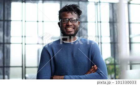 Handsome cheerful african american executive business man at the workspace office 101330033