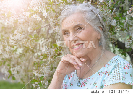 beautiful old woman posing in park in spring beautiful old woman posing in park in spring 101333578