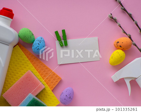 Detergent with Easter decoration on pink background with copy space 101335261
