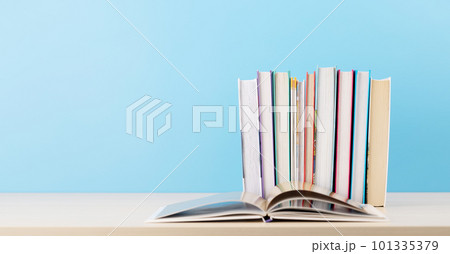 Old books on a table, with one book open Old books on a table, with one book open 101335379