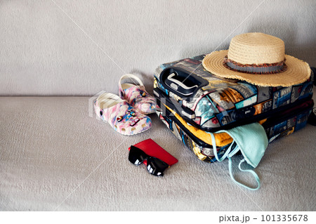 Luggage and suitcase packing for vacation on the bed, closeup 101335678