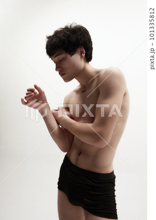 Strong, muscle, relief body. Young brunette guy posing shirtless in underwear against white studio background 101335812