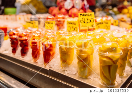 Assortment of fresh cut fruit in plastic containers in market grocery display case, Barcelona, Spain 101337559