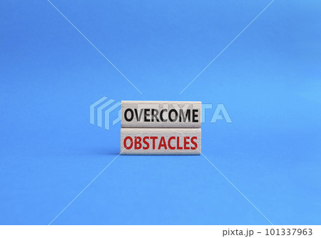 Overcome obstacles symbol. Concept words Overcome obstacles on wooden blocks. Beautiful blue background. Business and Overcome obstacles concept. Copy space. Overcome obstacles symbol. Concept words Overcome obstacles on wooden blocks. Beautiful blue background. Business and Overcome obstacles concept. Copy space. 101337963