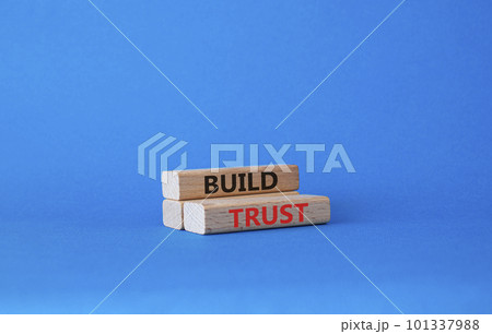 Build trust symbol. Wooden blocks with words Build trust. Beautiful blue background. Business and Build trust concept. Copy space. Build trust symbol. Wooden blocks with words Build trust. Beautiful blue background. Business and Build trust concept. Copy space. 101337988