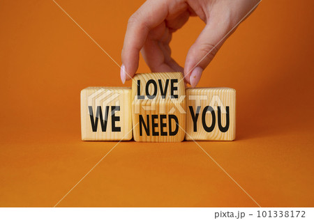 We love and need You symbol. Businessman Hand turns cubes and changes word We need you to We love you. Beautiful orange background. Business and We love and need You concept. Copy space 101338172