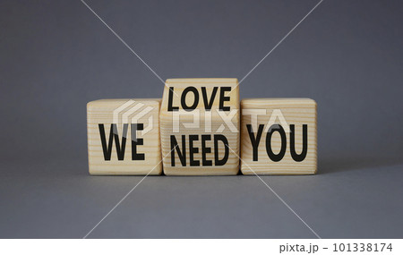 We love and need You symbol. Turned wooden cubes with words We need you and We love you. Beautiful grey background. Business and We love and need You concept. Copy space 101338174