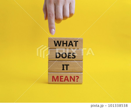 What does it mean symbol. Wooden blocks with words What does it mean. Beautiful yellow background. Businessman hand. Business and What does it mean concept. Copy space. 101338538