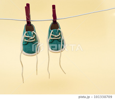 Baby shoes hanging on the clothesline. Newborn concept 101338709