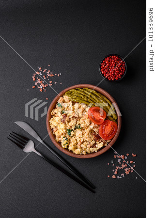 Delicious scramble with salmon, sun-dried tomatoes, spinach, spices and herbs Delicious scramble with salmon, sun-dried tomatoes, spinach, spices and herbs 101339696