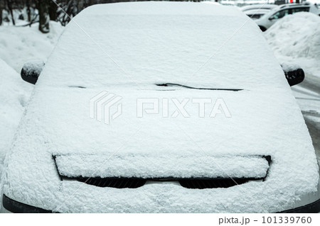 parked car in city parking blocked by snowfall, windshield with windshield wipers covered with snow, blocked lost car in snowy winter morning, nobody. parked car in city parking blocked by snowfall, windshield with windshield wipers covered with snow, blocked lost car in snowy winter morning, nobody. 101339760