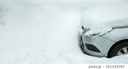 a parked car near a snowdrift covered with a pile of snow on the hood and blocked by precipitation on a cold winter day. a parked car near a snowdrift covered with a pile of snow on the hood and blocked by precipitation on a cold winter day. 101339767