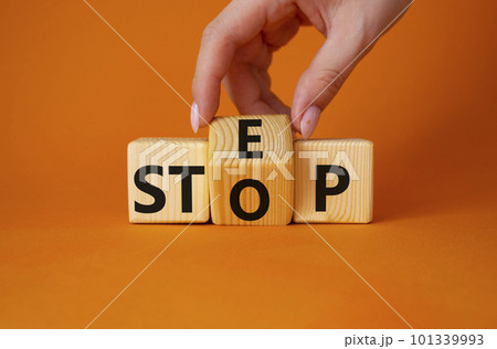 Step vs Stop symbol. Businessman hand turns wooden cubes and changes the word Stop to Step. Beautiful orange background. Step vs Stop and business concept. Copy space 101339993