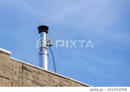 Shiny galvanized ventilation pipe on the roof of the building. Shiny galvanized ventilation pipe on the roof of the building. 101341048