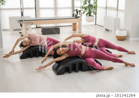 Balanced Body Pilates Arc. Three asian women exercising on pilates