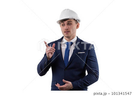 Handsome man in a suit and helmet shows the emotions of solving problem by pointing with his index finger. Concept in studio on a white background. Handsome man in a suit and helmet shows the emotions of solving problem by pointing with his index finger. Concept in studio on a white background. 101341547