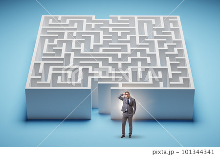 Businessman trying to find a way out of maze Businessman trying to find a way out of maze 101344341