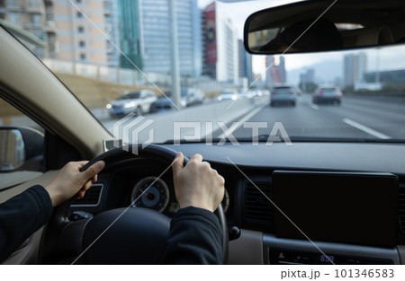 People driving car on city road 101346583