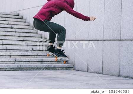 Asian woman skateboarder skateboarding in modern city Asian woman skateboarder skateboarding in modern city 101346585