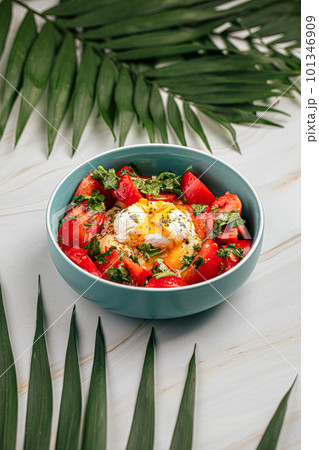 Hummus bowl with poached egg and tomatoes Hummus bowl with poached egg and tomatoes 101346909