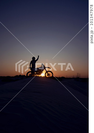Motorcycle, success and person silhouette celebrating victory against a night, sky and background in nature. Sports, motorbike and biker stop for accomplishment, achievement and biking on dirt road 101347978